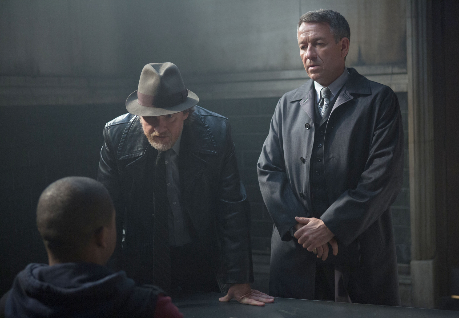GOTHAM: Detective Harvey Bullock (Donal Logue, C) and Alfred Pennyworth (Sean Pertwee, R) interview a suspect with information on Bruce and Selina's whereabouts in the "Lovecraft" episode of GOTHAM airing Monday, Nov. 24 (8:00-9:00 PM ET/PT) on FOX. Â©2014 Fox Broadcasting Co. Cr: Jessica Miglio/FOX